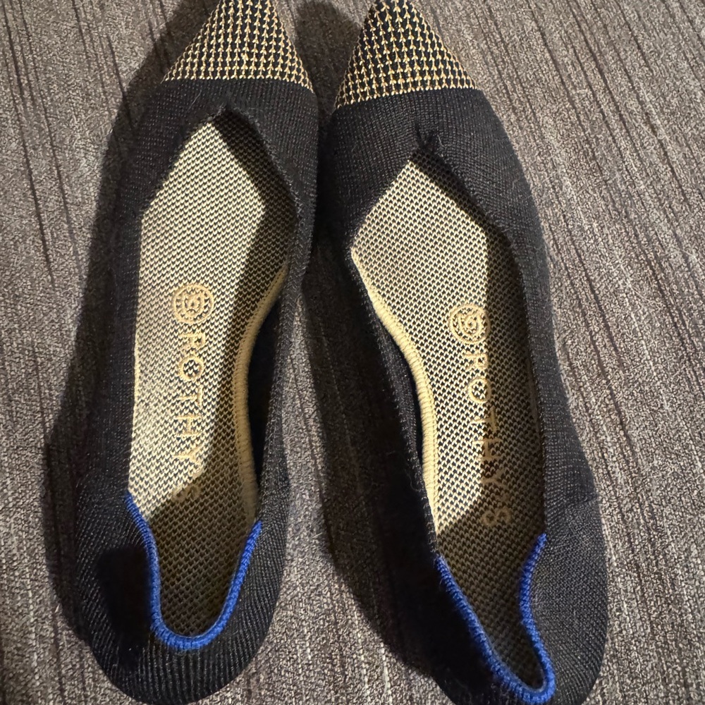 Rothy's The Point flats in black with a gold houndstooth cap toe